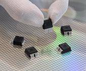 Mitarbeiterin präsentiert in der Halbleiterfabrik von Bosch in Dresden mikromechanische Sensoren über einem 300-Millimeter-Wafer