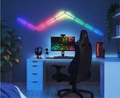 Eine gezackte Linie aus Nanoleaf-Leuchtelementen leuchtet an einer Wand in Regenbogenfarben