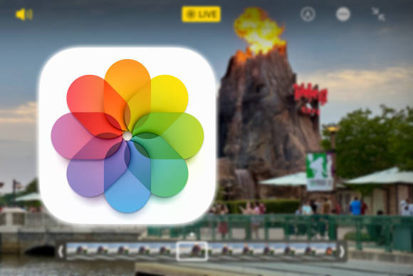 Ein unscharfer Vulkan im Hintergrund, das Symbol der Fotos-App im Vordergrund 
