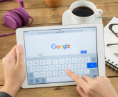 Nutzer surft auf Tablet mit Google